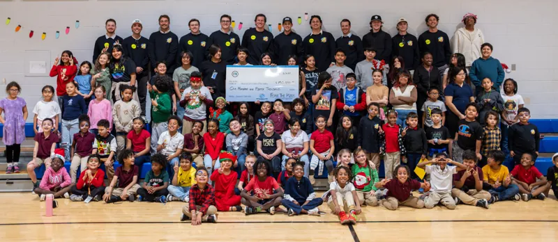 Fore The Kids members presenting a check to kids at the Boys and Girls Club Gabel Branch