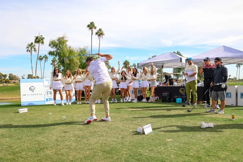 A golfer tees off at the FTK Golf Tournament