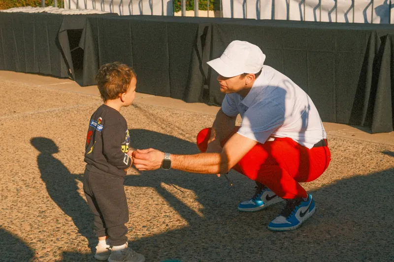 A volunteer with a young fan